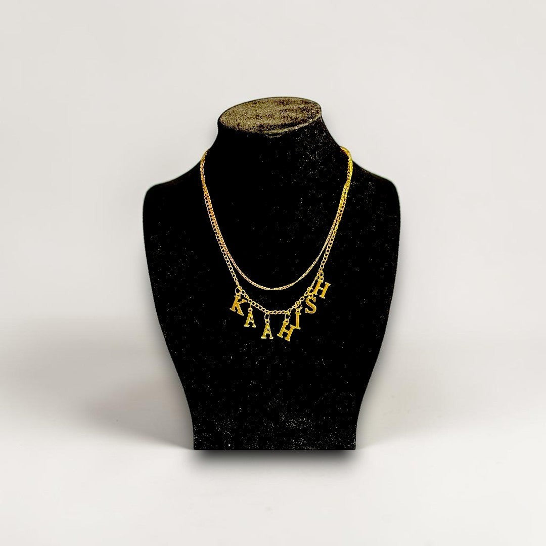 Handmade Trinkets personalised gold letter name necklace with pearl chain, featuring gold-tone letter charms spelling 'KAIAH' on a delicate pearl chain.